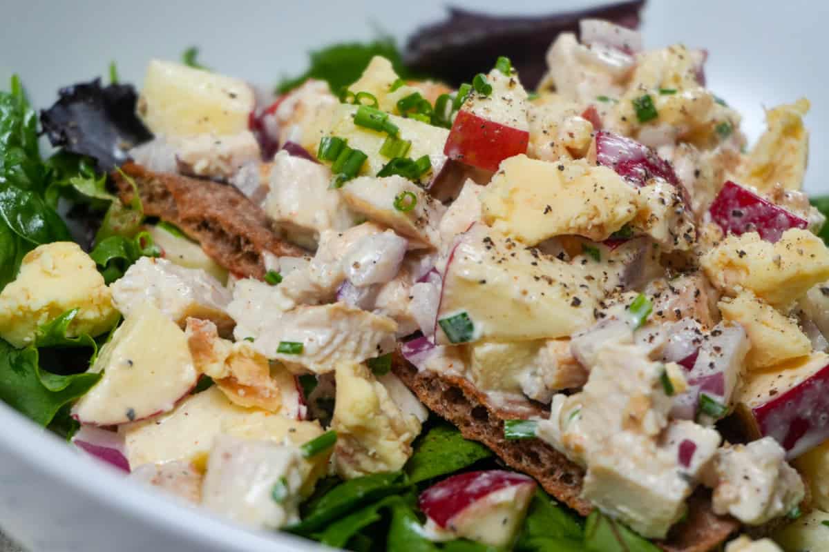 Apple Stilton chicken salad on Wasa crispbread over mixed greens with chives and crumbled cheese.