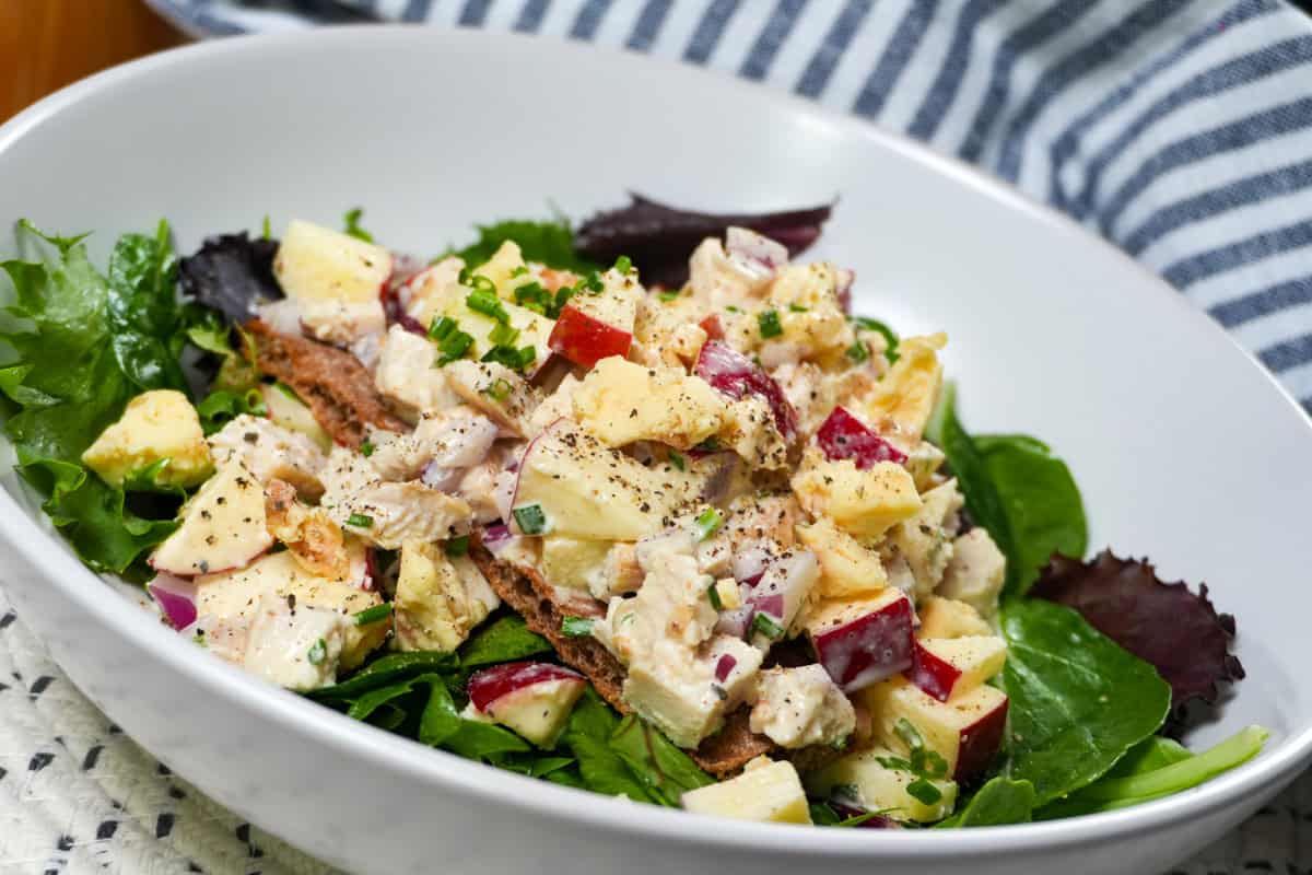 Apple Stilton chicken salad on Wasa crispbread over mixed greens with chives and crumbled cheese.