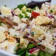 Apple Stilton chicken salad on Wasa crispbread over mixed greens with chives and crumbled cheese.
