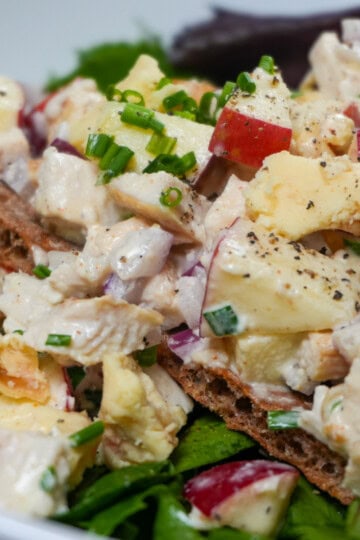 Apple Stilton chicken salad on Wasa crispbread over mixed greens with chives and crumbled cheese.
