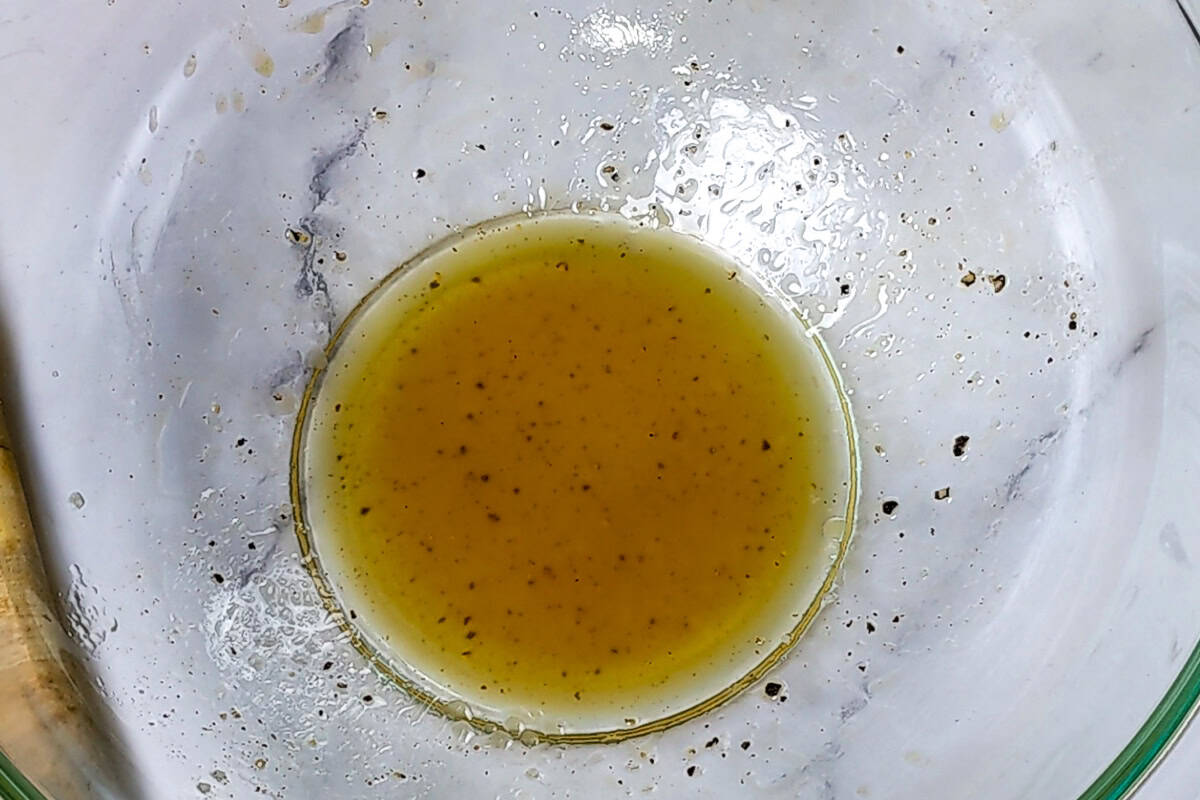 homemade sherry and extra virgin olive oil vinaigrette in a glass mixing bowl.