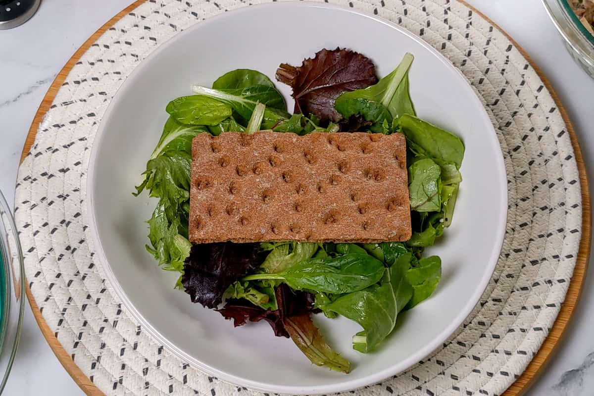 dressed greens with a wasa crack on top.