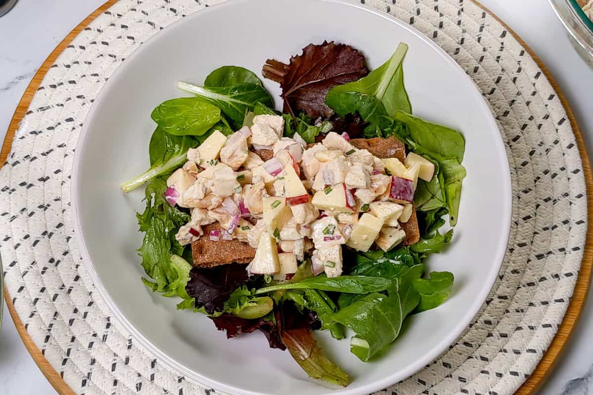 Apple Stilton chicken salad on Wasa crispbread over mixed greens with chives and crumbled cheese.