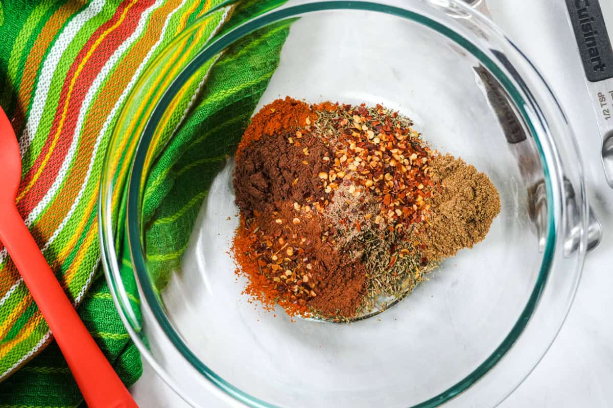 a mixture of spices poured into a glass bowl to make a ras el haount substitute.