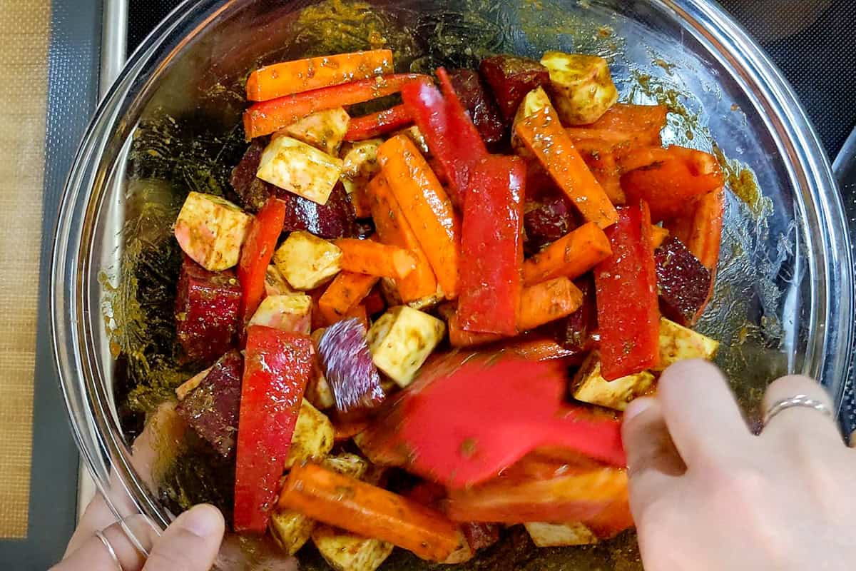Cut carrots, Japanese sweet potatoes, red bell peppers, beets, ras el hanout, and avocado oil.