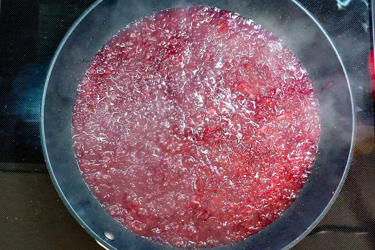 Grated beets and minced onions simmering in a large all-clad non-stick frying pan.