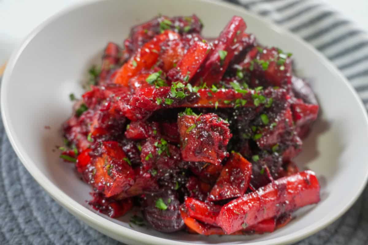 Roasted sweet potatoes, carrots, red peppers, and beets coated in a glossy red beet glaze.
