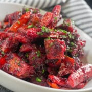 Roasted sweet potatoes, carrots, red peppers, and beets coated in a glossy red beet glaze.