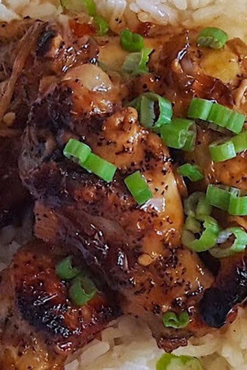 Soy ginger chicken drumettes over jasmine rice with sliced scallions.
